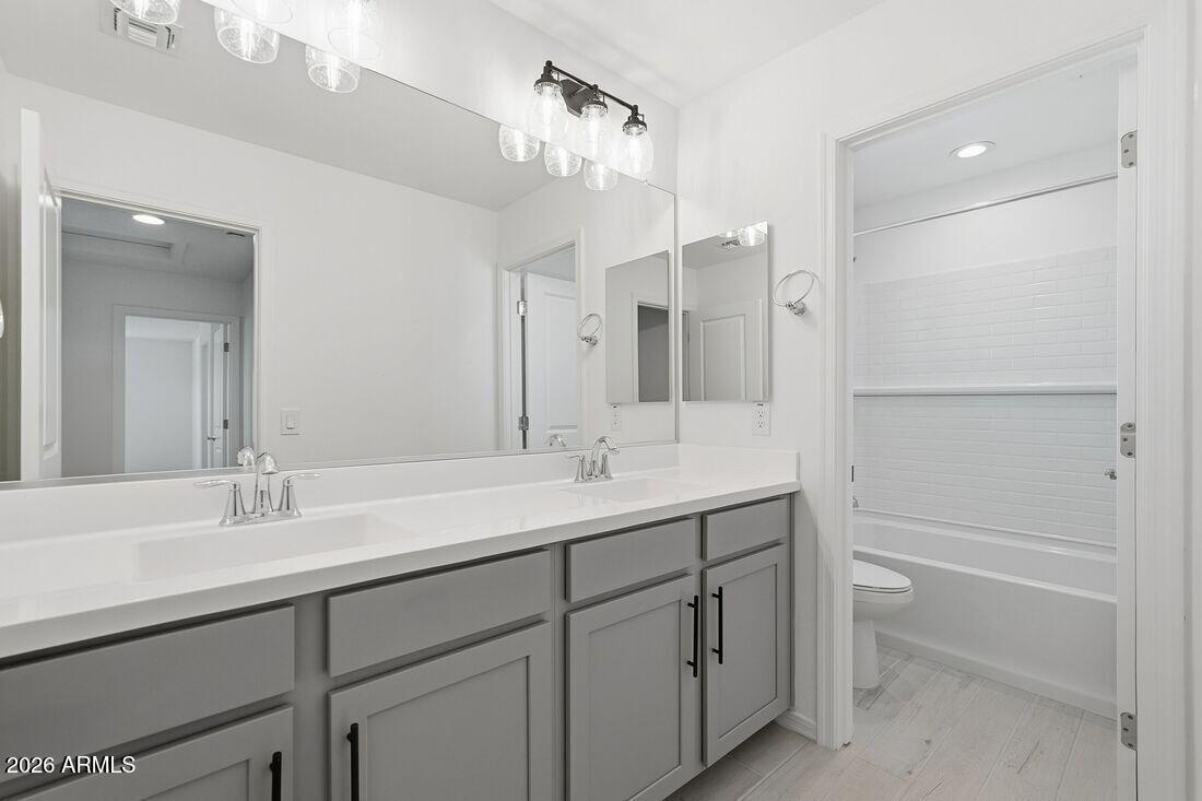 10048 West Piccadilly Road Avondale, AZ 85392 - Photo 22 of 49 a bathroom with a sink double vanity granite tub and a mirror