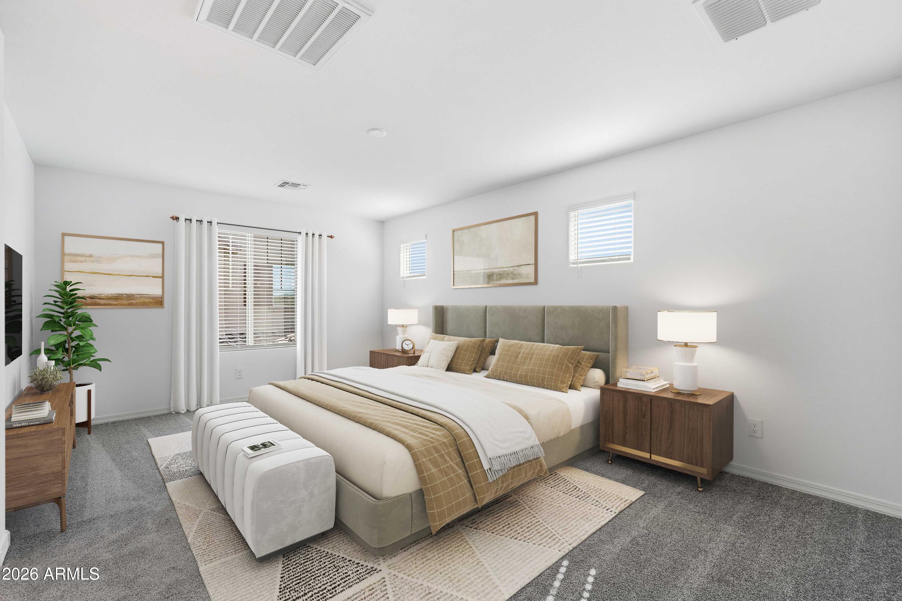 10048 West Piccadilly Road Avondale, AZ 85392 - Photo 5 of 49 a bedroom with a bed and a couch