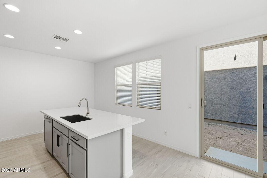 10048 West Piccadilly Road Avondale, AZ 85392 - Photo 7 of 49 a kitchen with a sink and a refrigerator