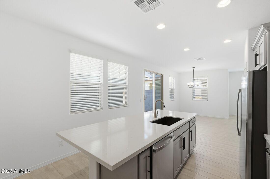 10048 West Piccadilly Road Avondale, AZ 85392 - Photo 10 of 49 a kitchen with stainless steel appliances granite countertop a sink a refrigerator and a stove