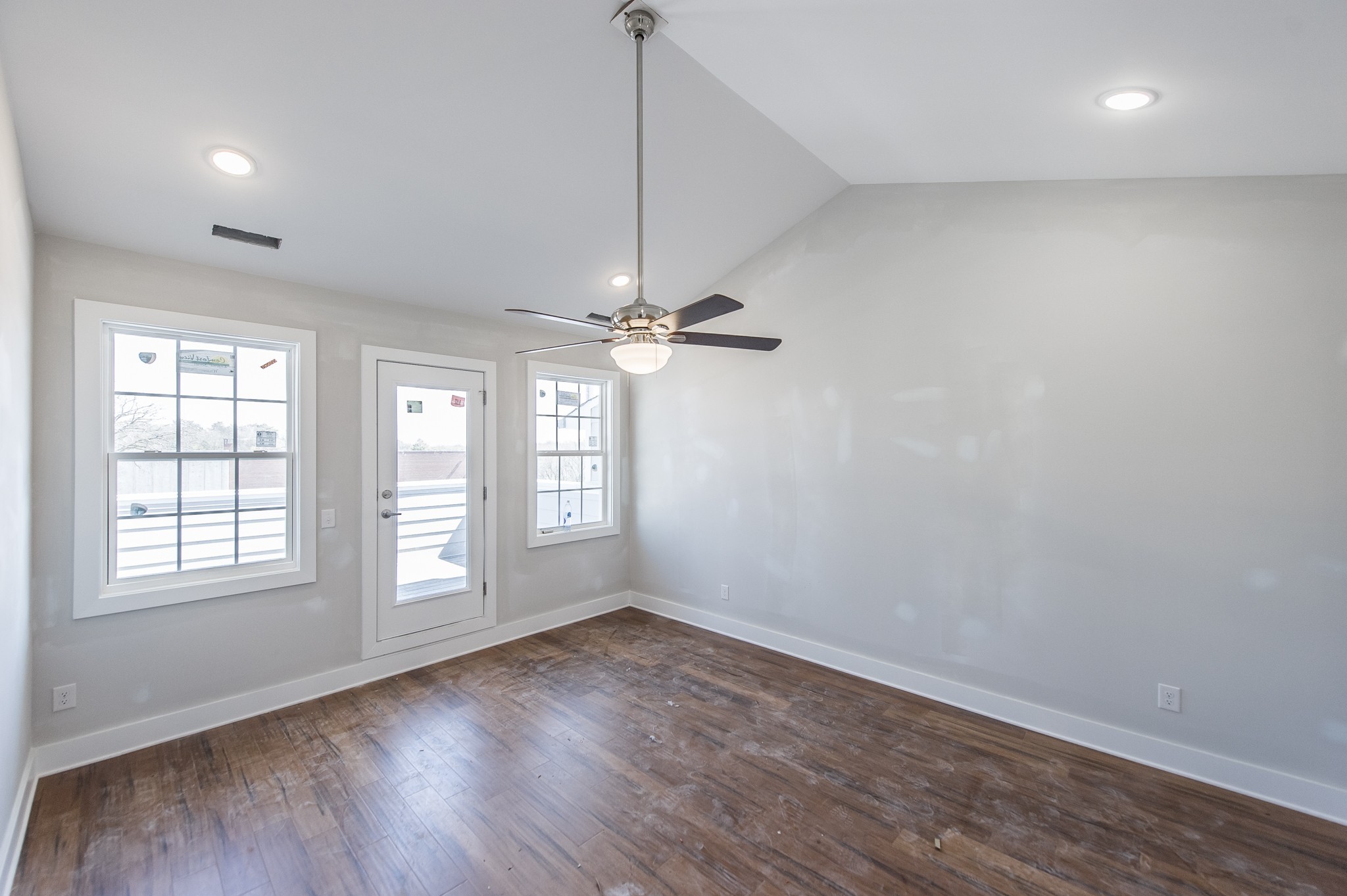 421 Elysian Fields Road, Unit 4 Nashville, TN 37211 - Photo 16 of 26 an empty room with wooden floor chandelier fan and windows