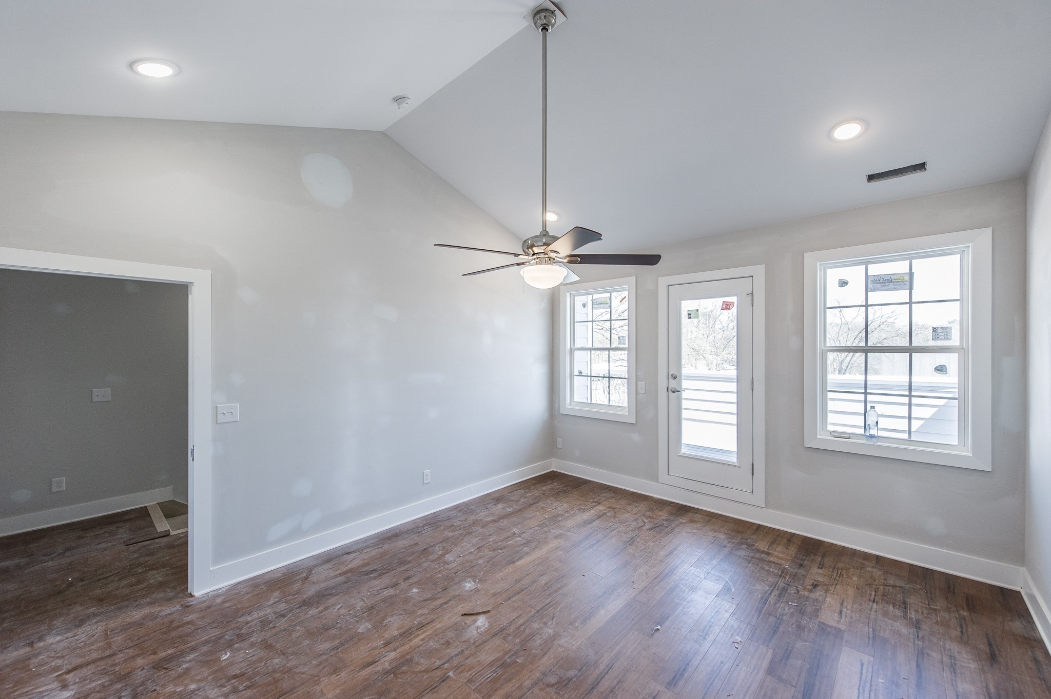 421 Elysian Fields Road, Unit 4 Nashville, TN 37211 - Photo 22 of 26 an empty room with wooden floor exposed radiator and windows