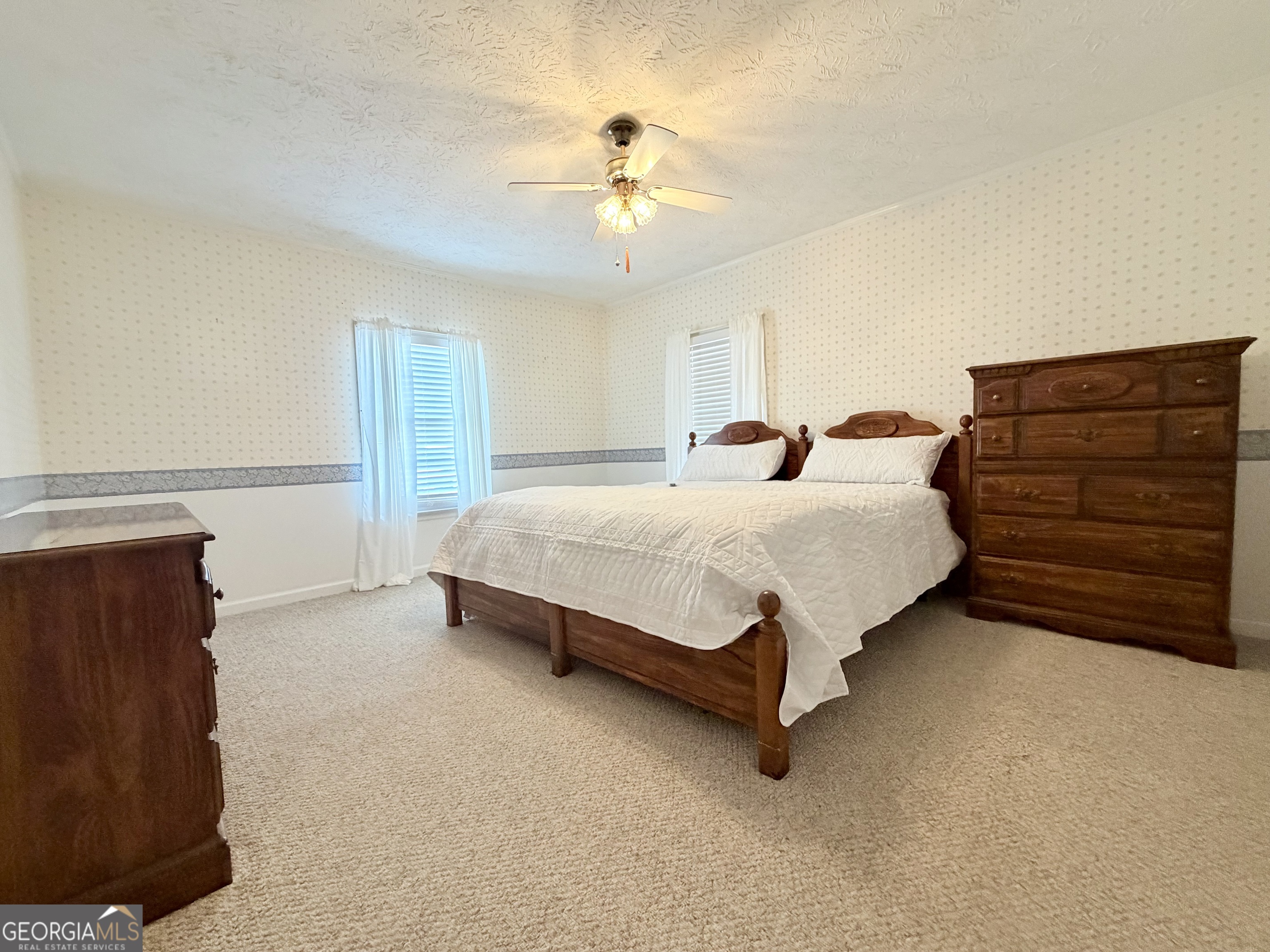 17 2nd Street McRae-Helena, GA 31037 - Photo 24 of 51 a bedroom with a bed and a ceiling fan