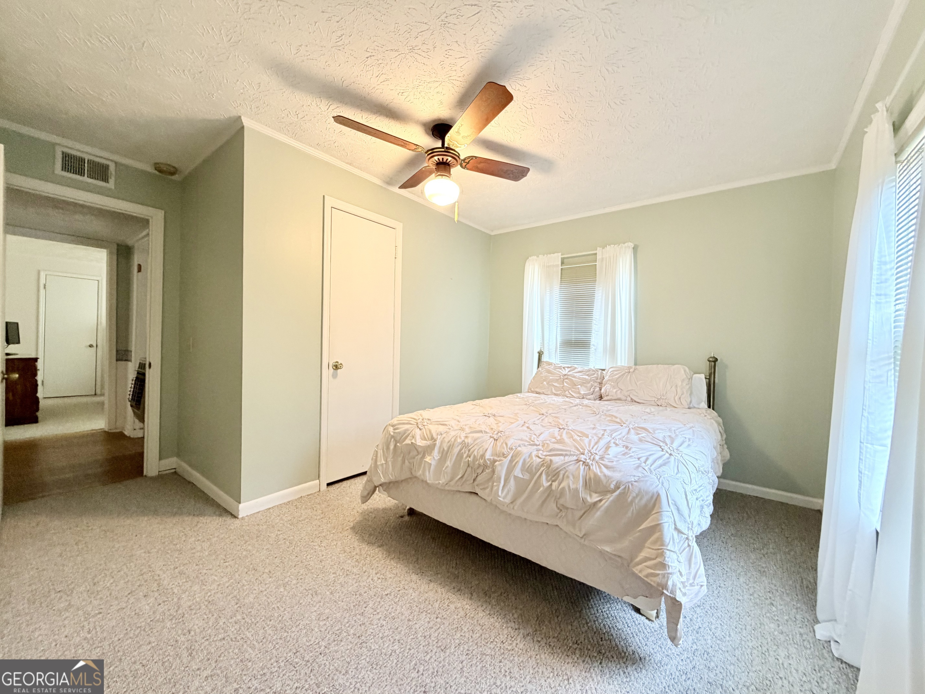 17 2nd Street McRae-Helena, GA 31037 - Photo 26 of 51 a bedroom with a bed and a chandelier