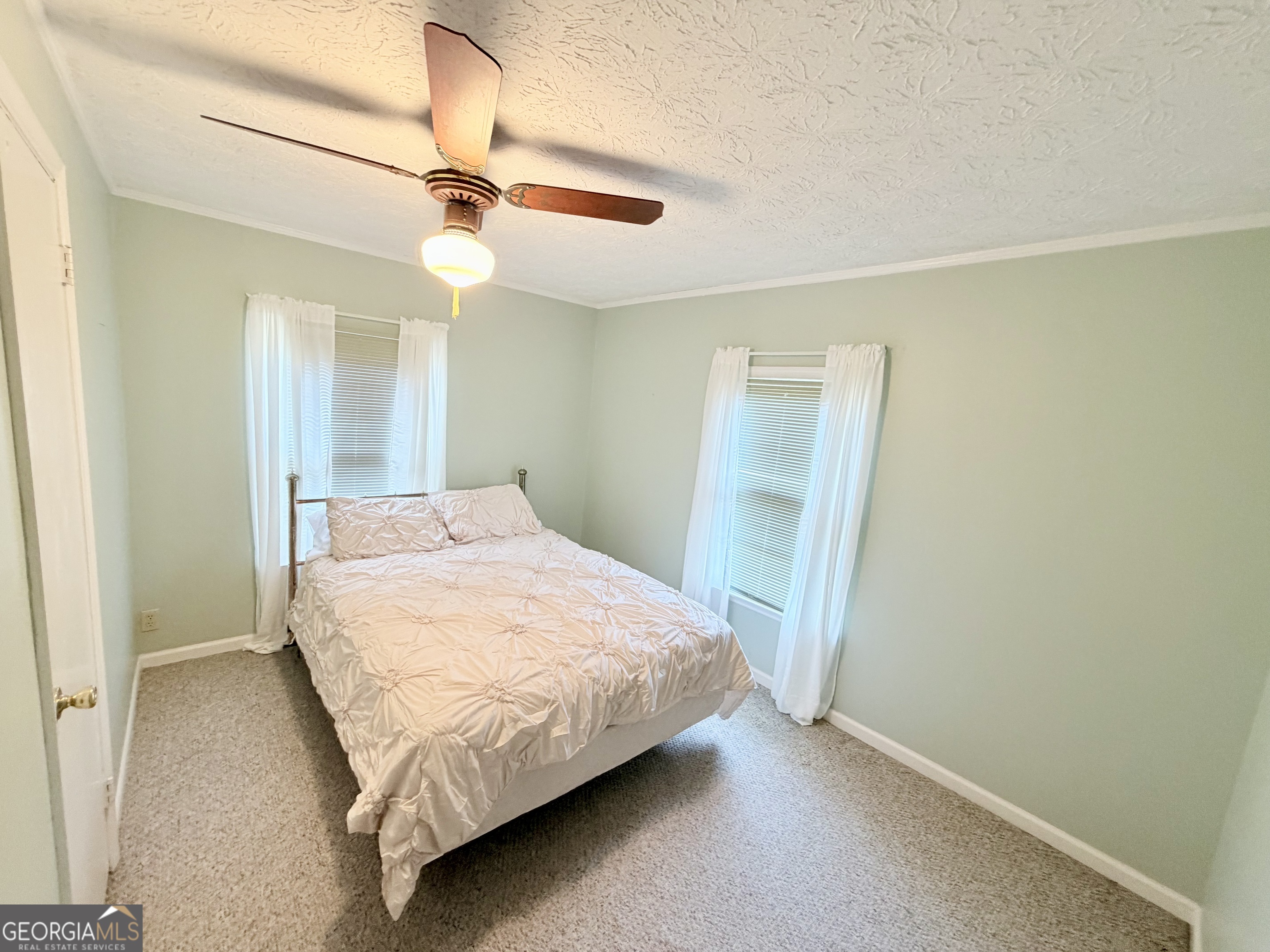 17 2nd Street McRae-Helena, GA 31037 - Photo 27 of 51 a bedroom with a bed and a ceiling fan