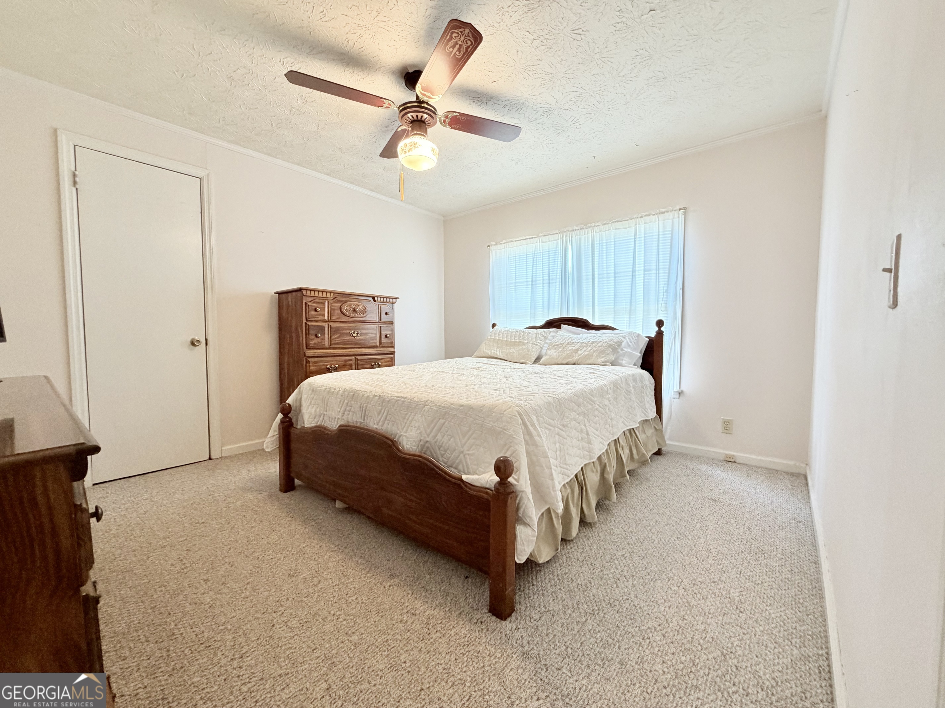 17 2nd Street McRae-Helena, GA 31037 - Photo 31 of 51 a bedroom with a bed chandelier and a window
