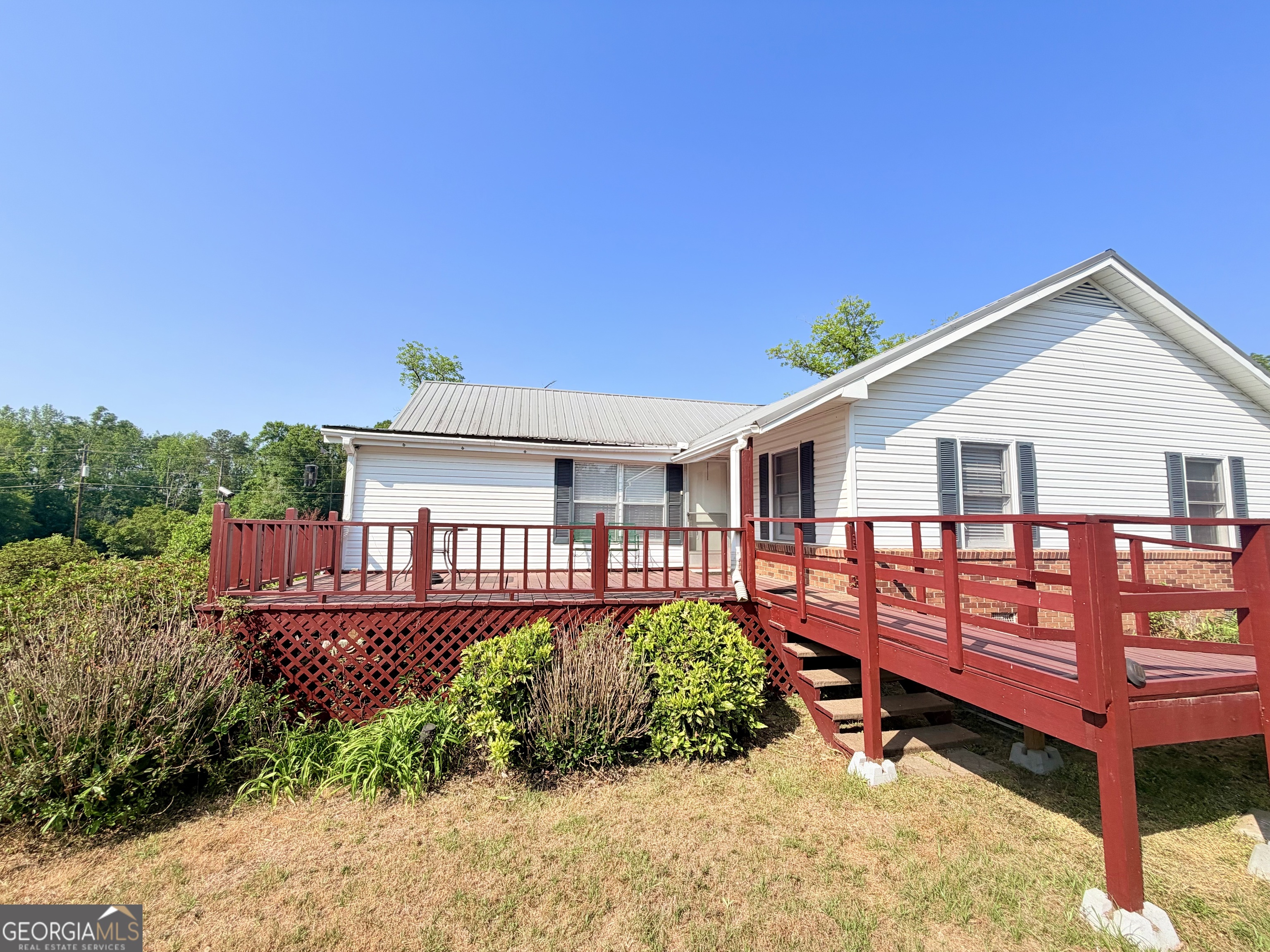 17 2nd Street McRae-Helena, GA 31037 - Photo 32 of 51 a view of a house with wooden deck and furniture
