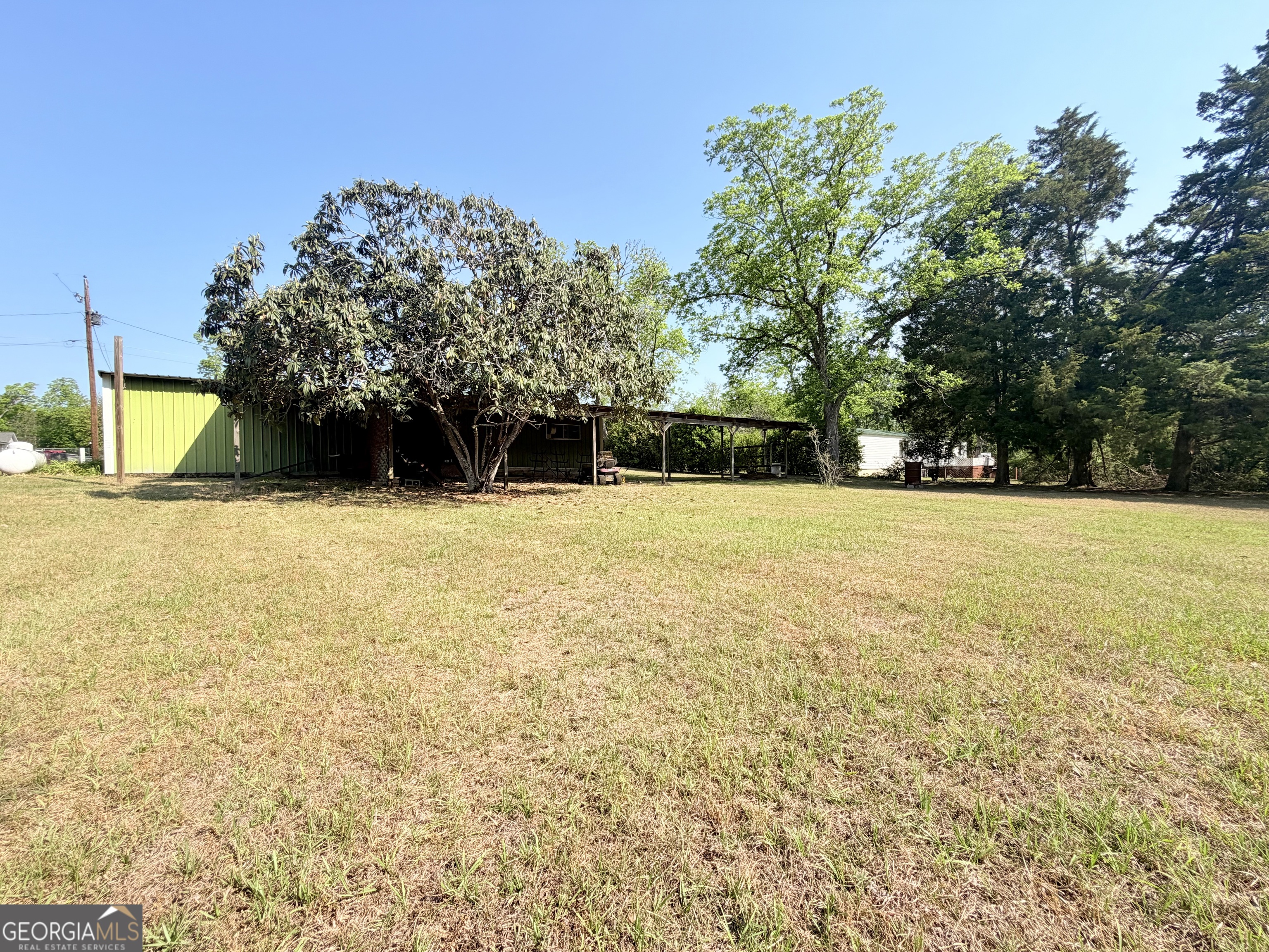 17 2nd Street McRae-Helena, GA 31037 - Photo 34 of 51 a view of a swimming pool with an outdoor space and seating area