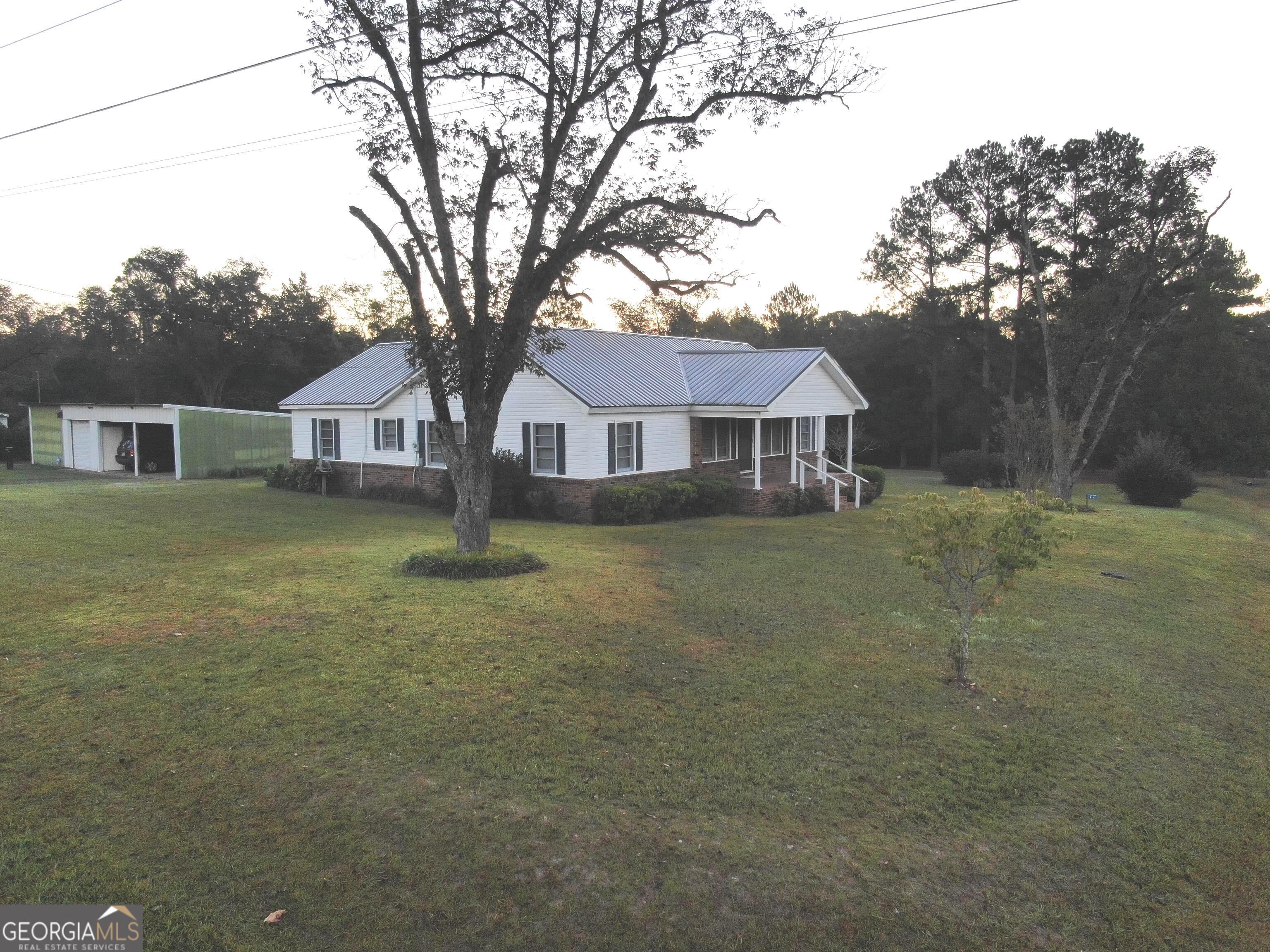 17 2nd Street McRae-Helena, GA 31037 - Photo 4 of 51 a front view of a house with a yard and trees