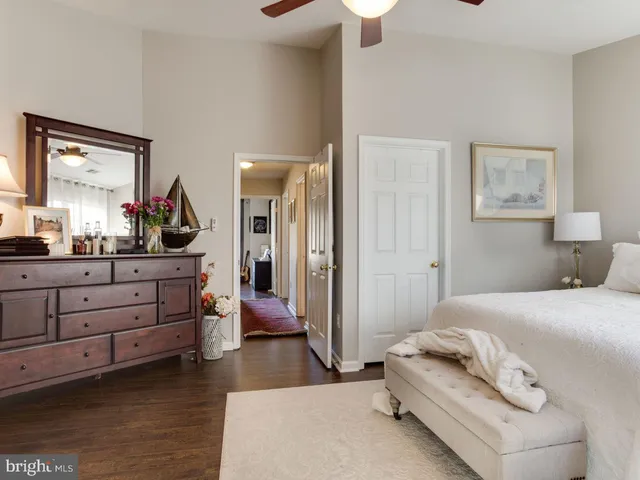 a bedroom with a bed and a large mirror