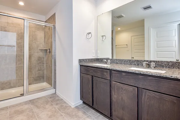 a bathroom with a granite countertop sink mirror and double
