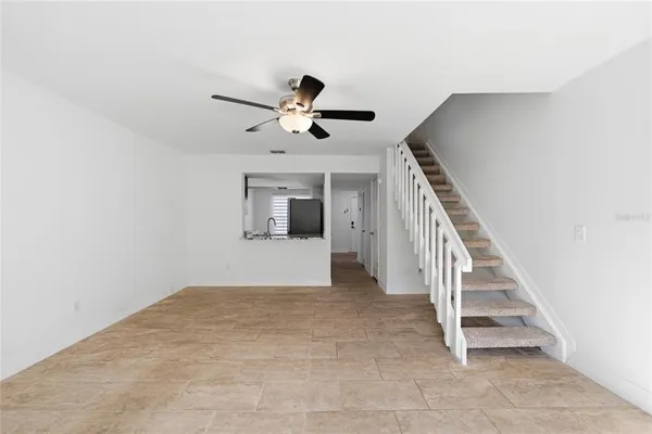 a view of entryway and hall with a ceiling fan