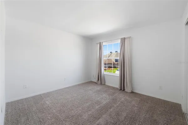 a view of an empty room and a window