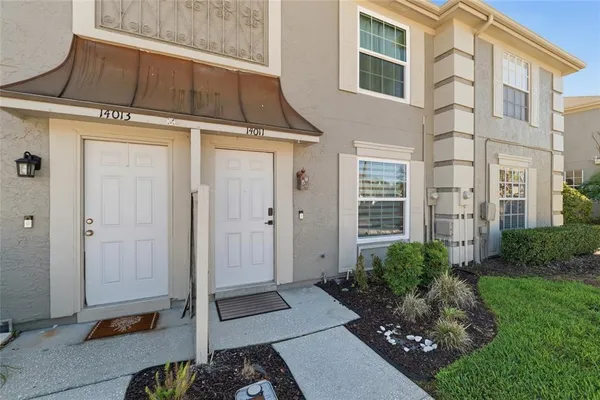 a view of a front door and small yard
