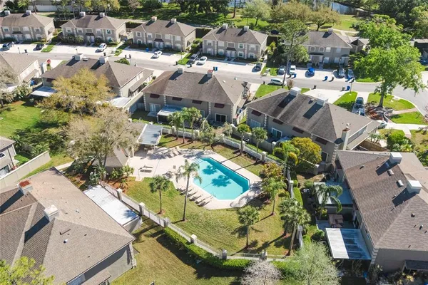 an aerial view of residential houses with outdoor space