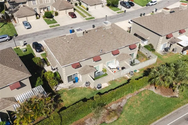 an aerial view of a house with a yard