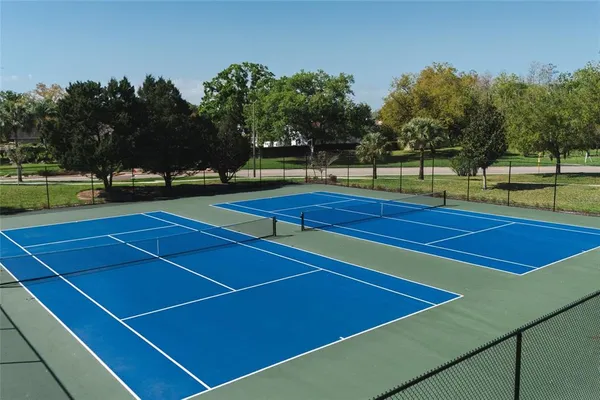 a view of tennis court with chairs
