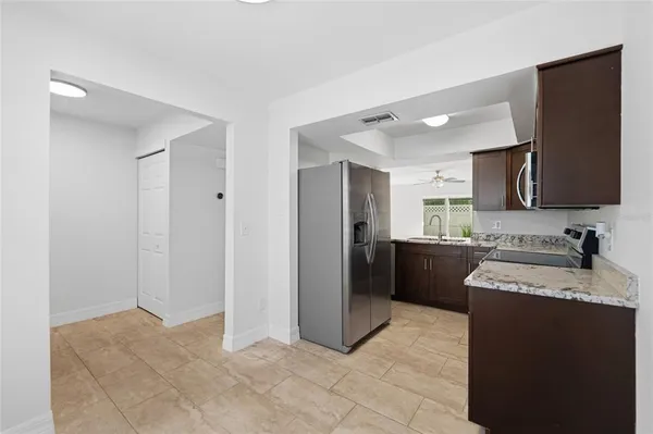 a kitchen with a refrigerator sink and stove
