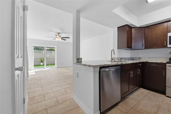 a kitchen with a sink cabinets and a window