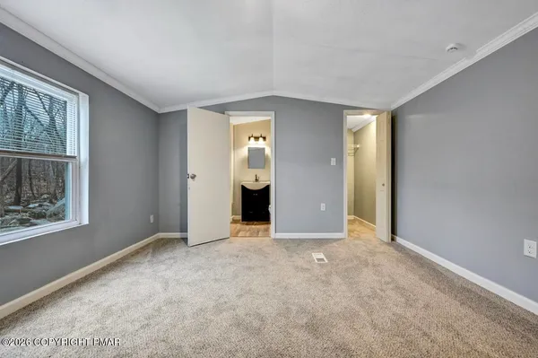 an empty room with windows and closet