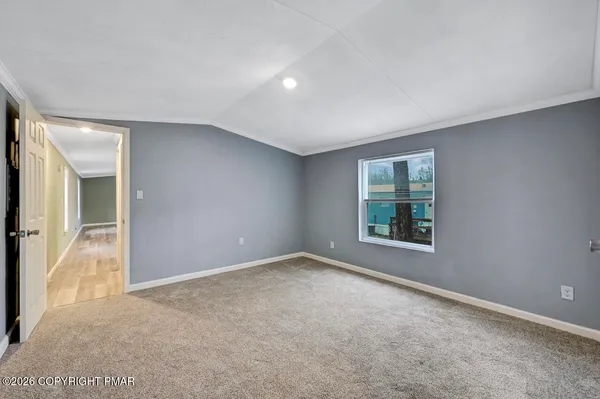 an empty room with windows and closet