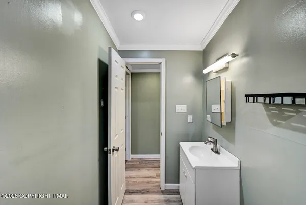 a bathroom with a sink a mirror and vanity