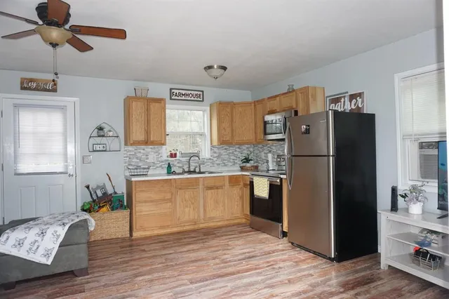 a kitchen with stainless steel appliances granite countertop a refrigerator and a sink