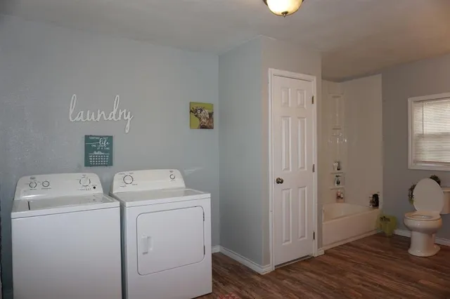 a view of bathroom with a washer and dryer