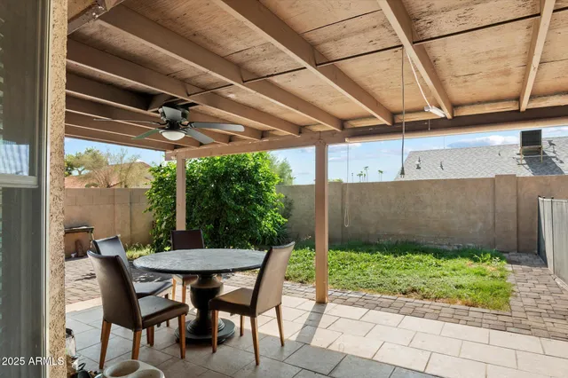 a view of a patio with table and chairs and potted plants