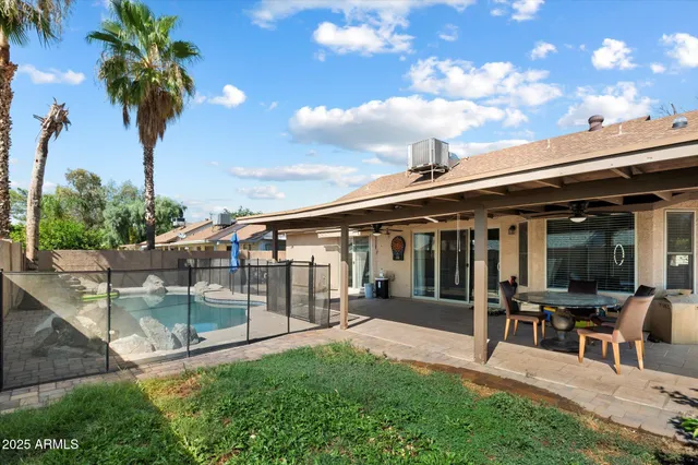 a view of a house with a backyard porch and sitting area