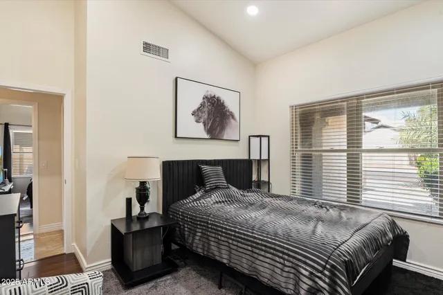 a bedroom with a large bed and a window