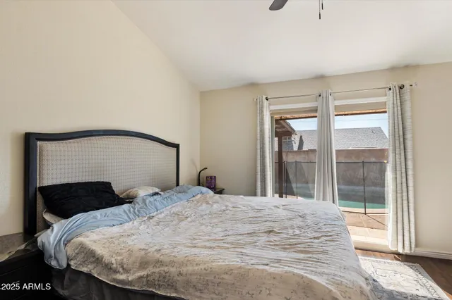 a bedroom with a large bed and a large window