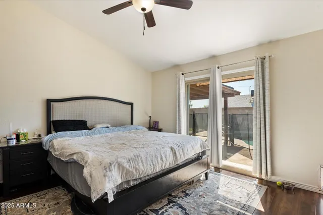 a bedroom with a bed and large window with balcony view