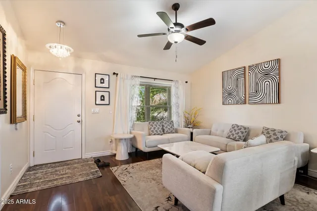 a living room with furniture and a ceiling fan