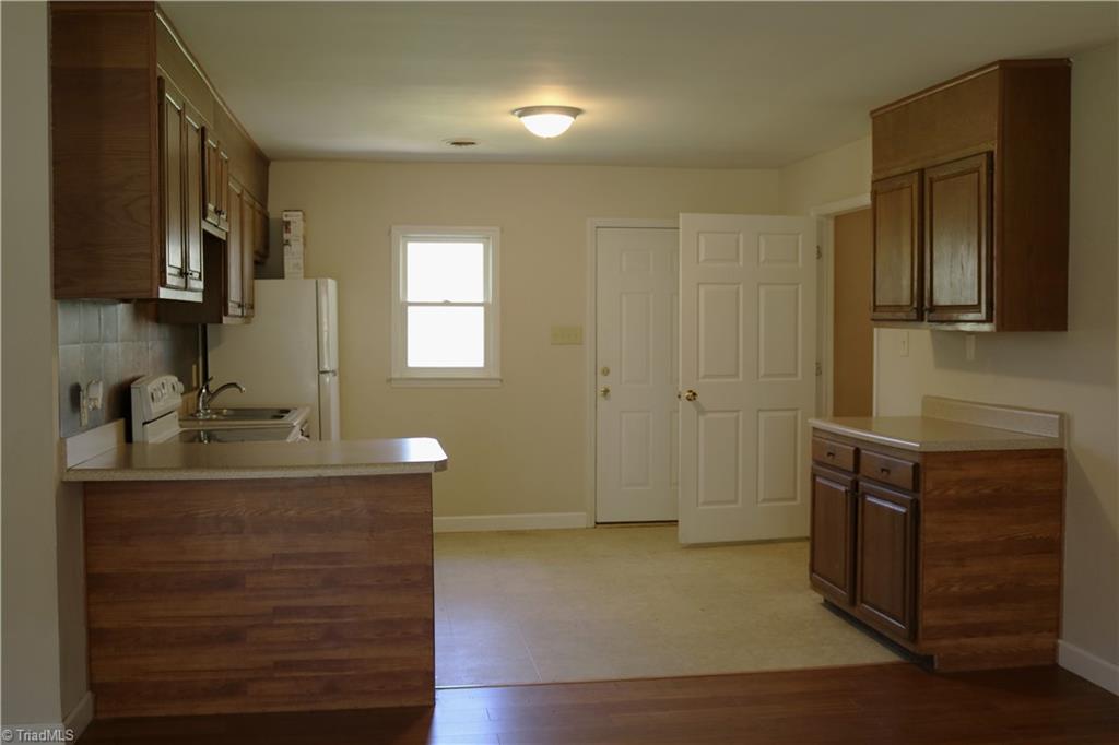 6327 Phillippi Road Julian, NC 27283 - Photo 3 of 16 Kitchen, Door to the Left goes into the Laundry Room then into the Garage.Other Door goes to the Backyard.