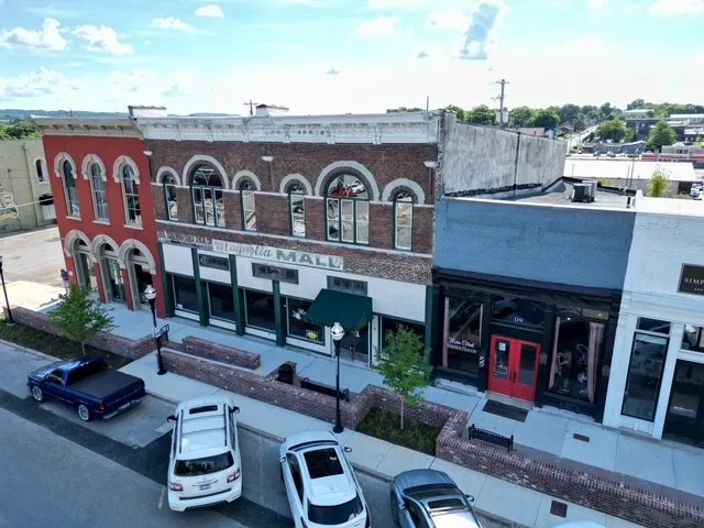 a front view of building with cars parked
