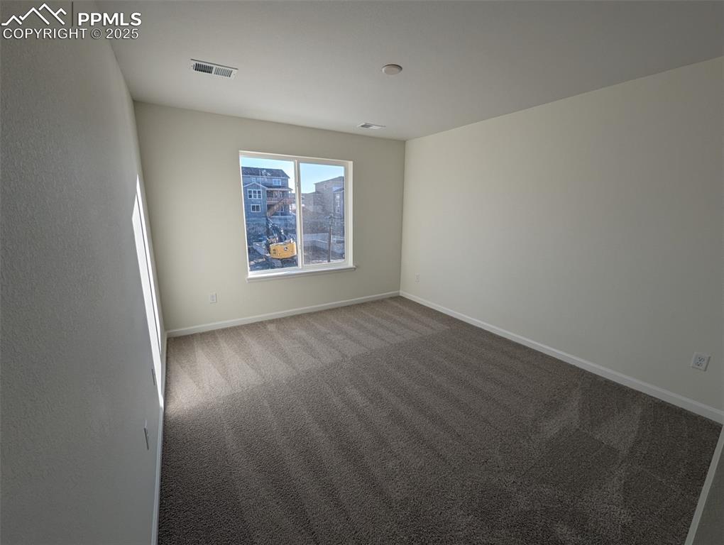 16966 Starfall Drive Monument, CO 80132 - Photo 14 of 18 an empty room with wooden floor and windows