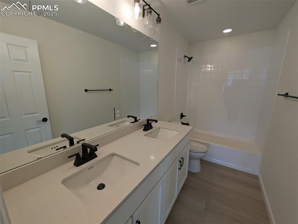 16966 Starfall Drive Monument, CO 80132 - Photo 15 of 18 a bathroom with a tub sink toilet and mirror
