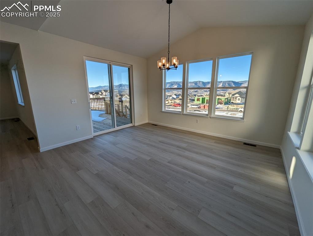 16966 Starfall Drive Monument, CO 80132 - Photo 3 of 18 a view of an empty room with wooden floor and a window