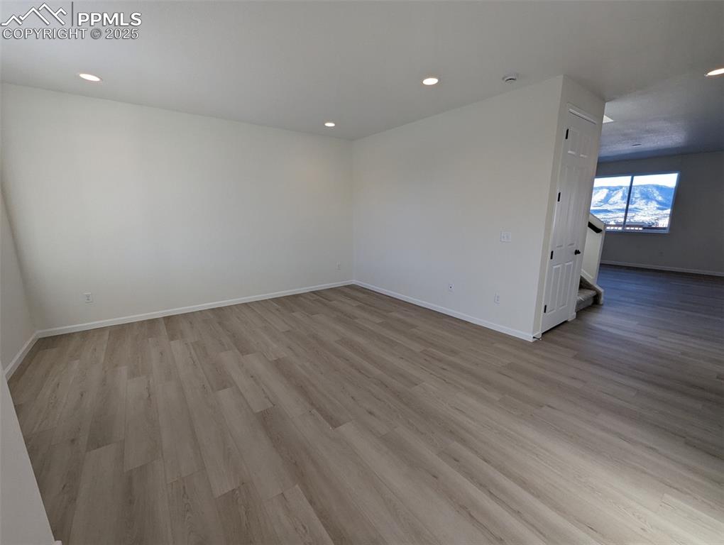 16966 Starfall Drive Monument, CO 80132 - Photo 6 of 18 an empty room with wooden floor and windows