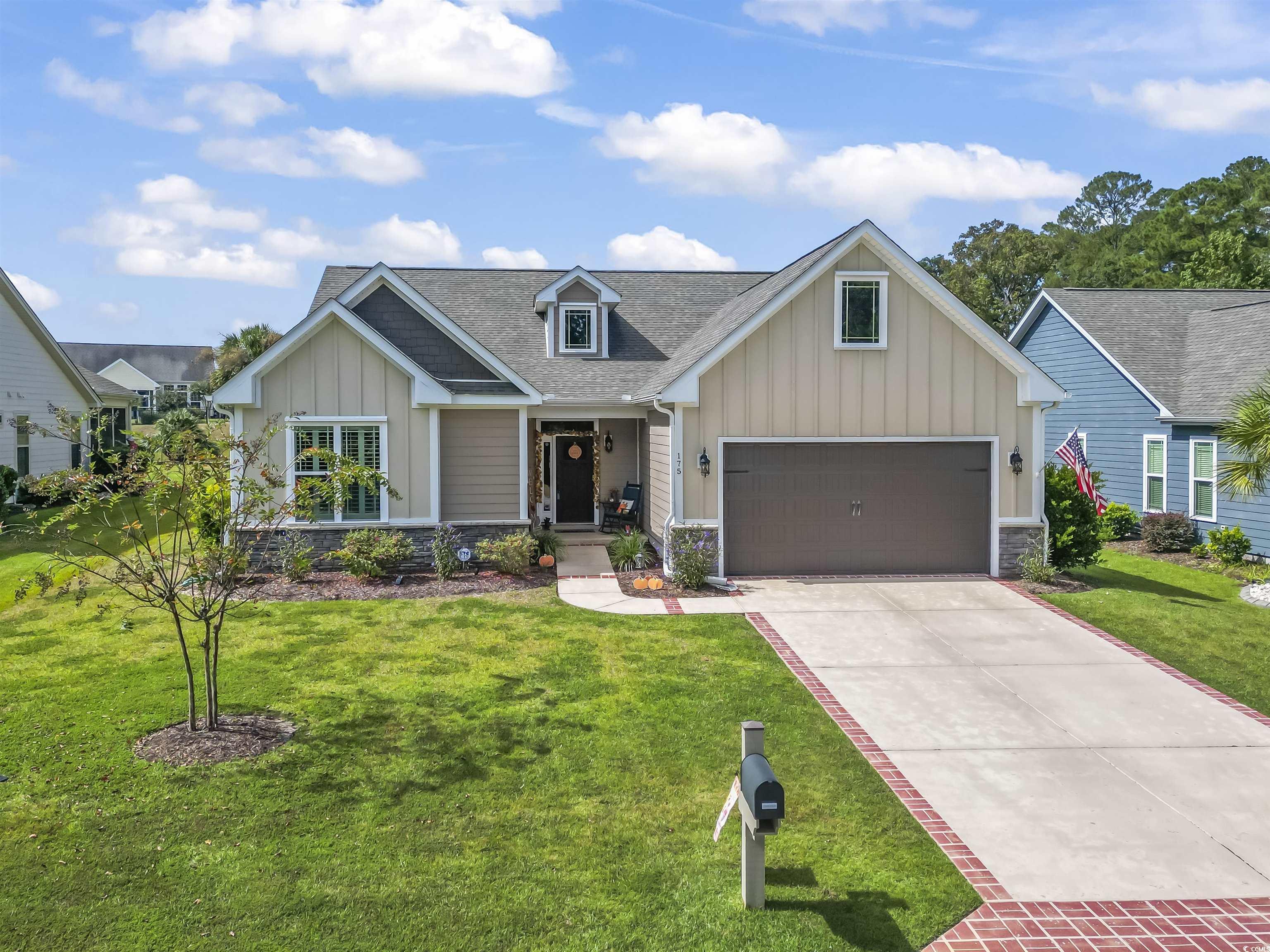 175 Rivers Edge Drive Conway, SC 29526 - Photo 1 of 37 Craftsman-style home with board and batten siding, stone siding, roof with shingles, a porch, and a front lawn