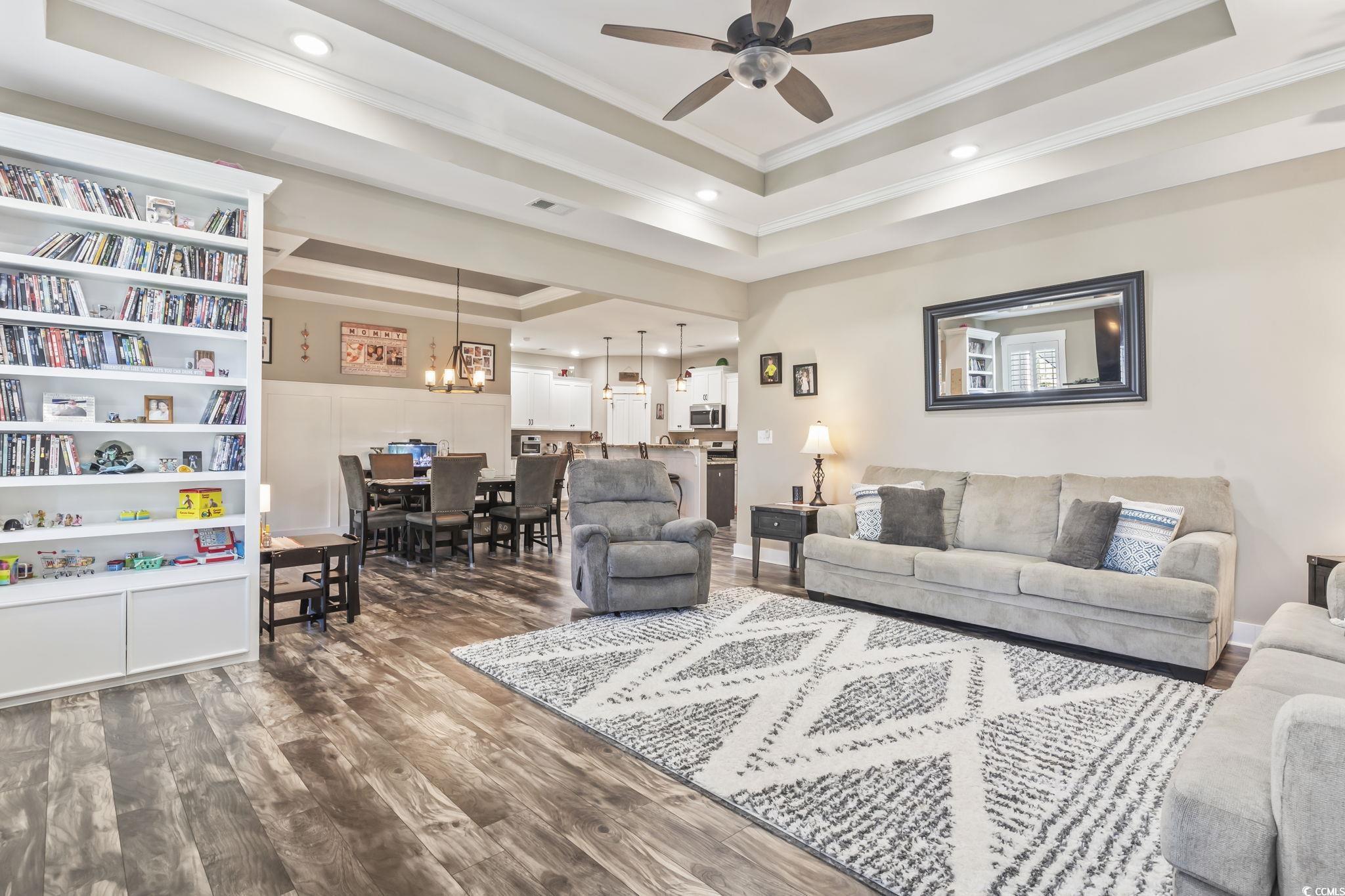 175 Rivers Edge Drive Conway, SC 29526 - Photo 14 of 37 Living area with a tray ceiling, dark wood-style floors, crown molding, a chandelier, and recessed lighting