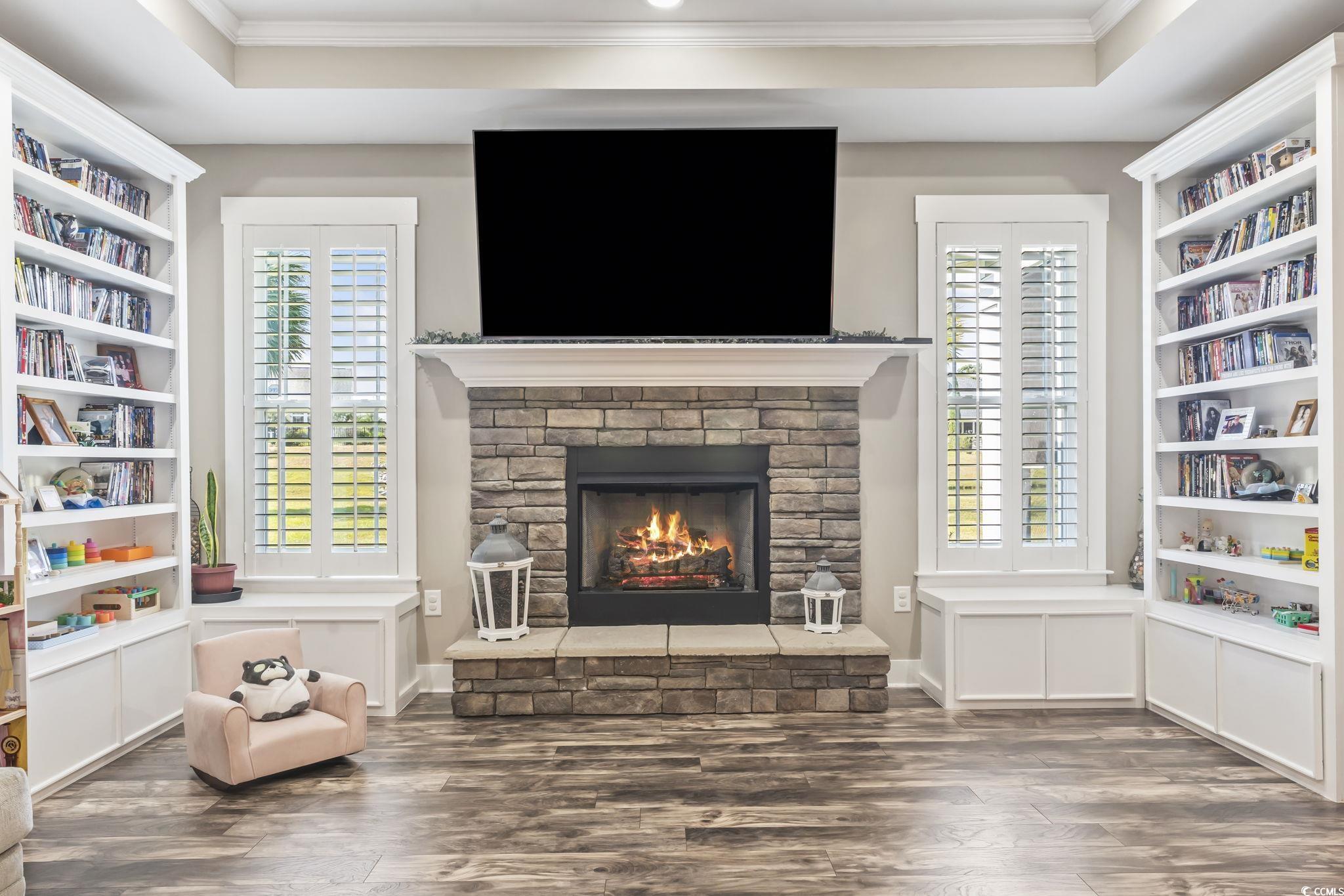 175 Rivers Edge Drive Conway, SC 29526 - Photo 15 of 37 Sitting room with dark wood finished floors, ornamental molding, a warm lit fireplace, and a raised ceiling