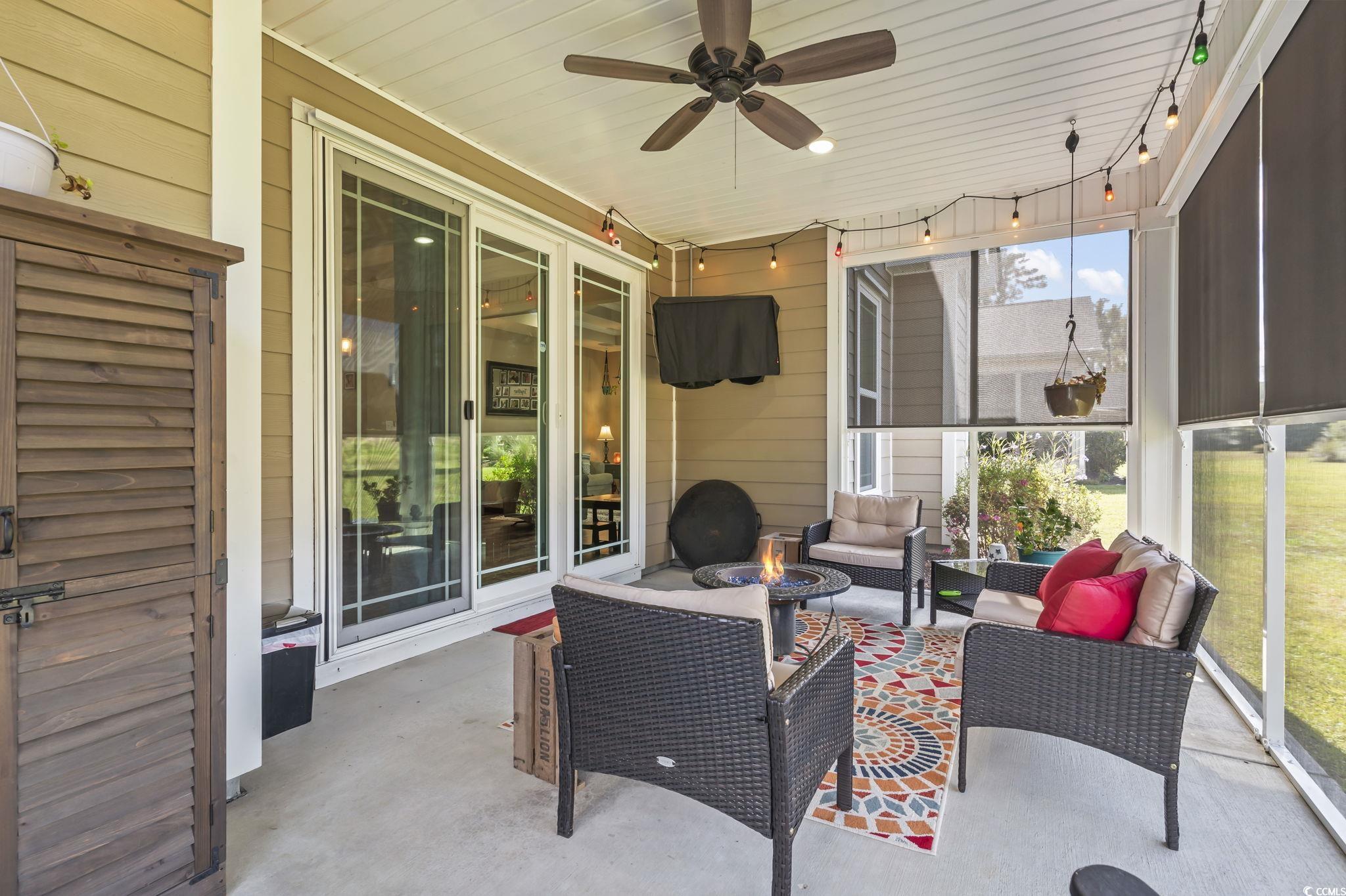 175 Rivers Edge Drive Conway, SC 29526 - Photo 28 of 37 View of patio / terrace with an outdoor living space with a fire pit, ceiling fan, and a sunroom