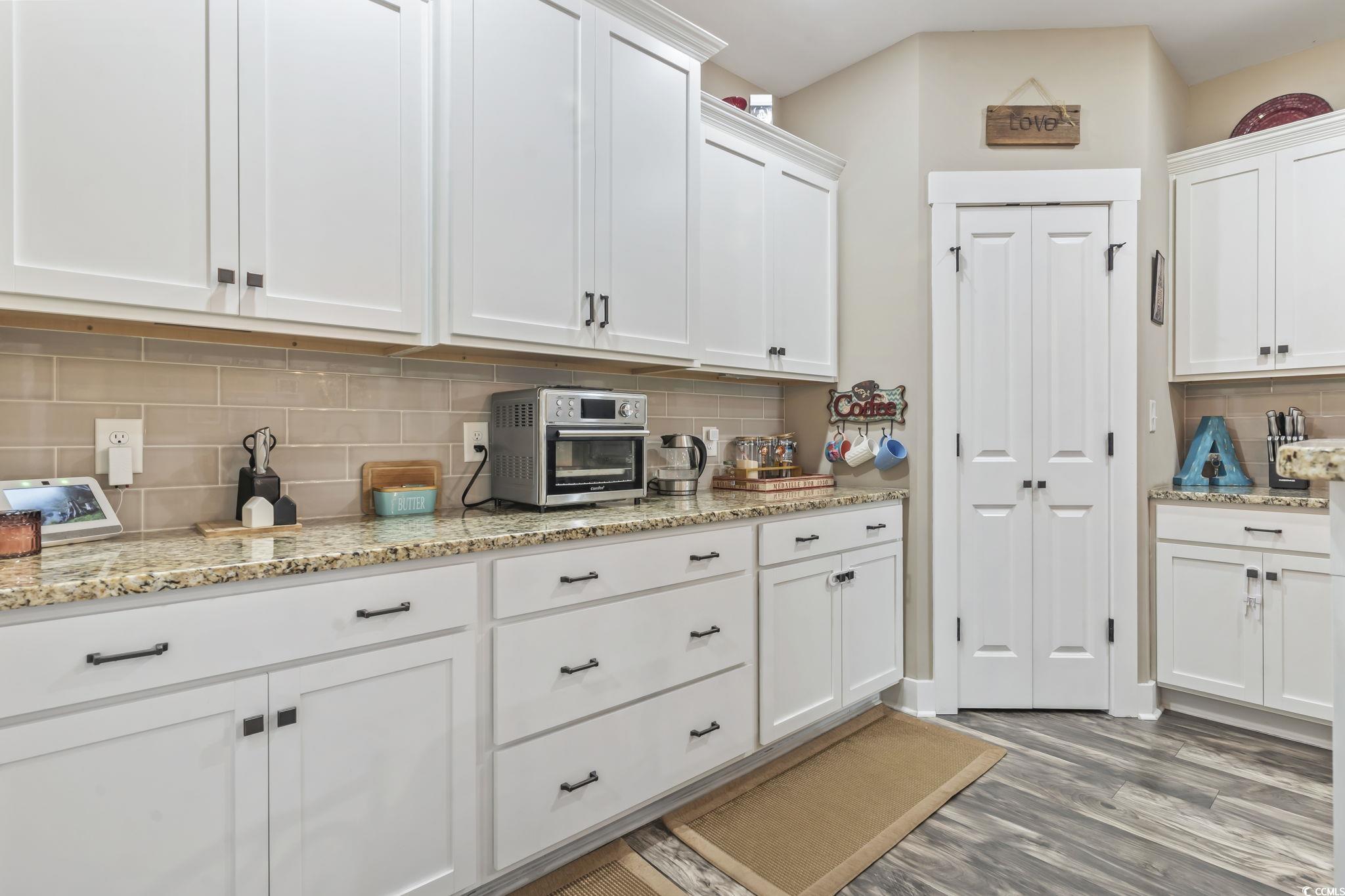 175 Rivers Edge Drive Conway, SC 29526 - Photo 8 of 37 Kitchen with white cabinetry, backsplash, and light stone counters