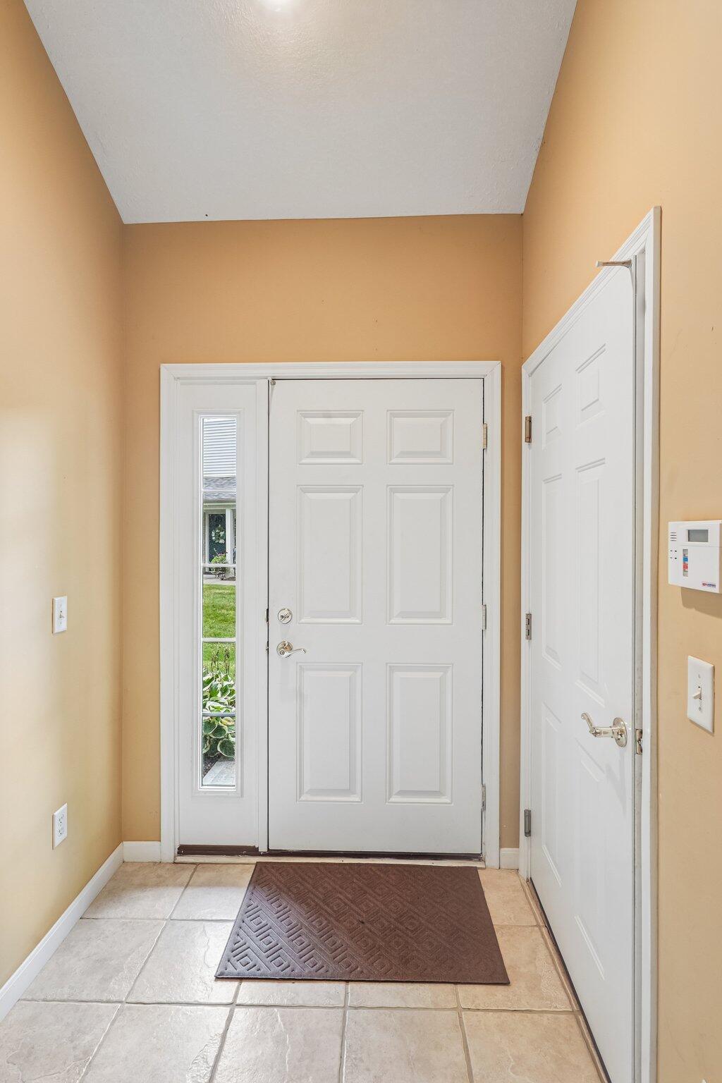 876 Flint Ridge Newport, KY 41076 - Photo 11 of 43 Entryway featuring a white paneled door with sidelight, overhead lighting, and tile flooring