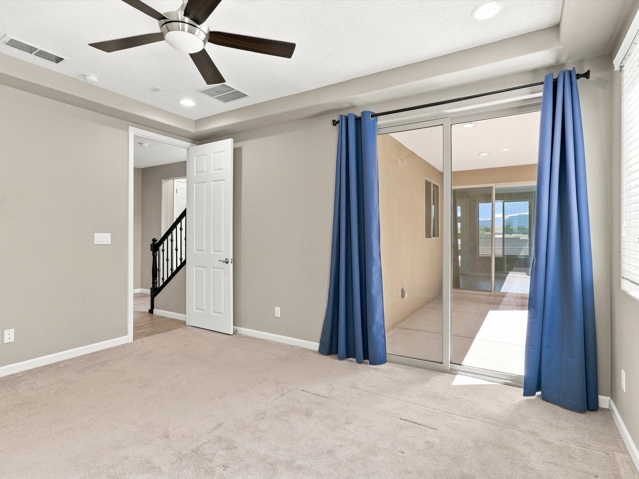 4642 Rail Runner Road Santa Fe, NM 87507 - Photo 20 of 74 The primary bedroom features a sliding door that opens directly to the covered patio.