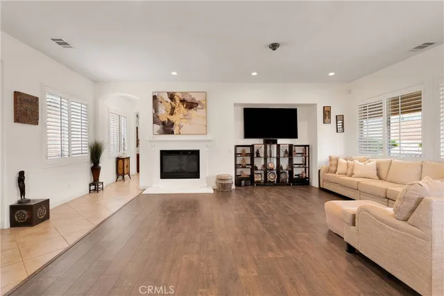 a view of a hallway and a livingroom with a window