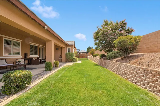 an aerial view of a house with a yard and potted plants