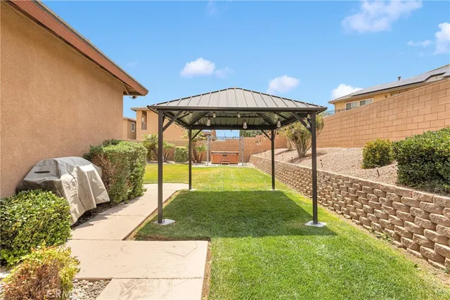 an aerial view of residential houses with outdoor space and ocean view